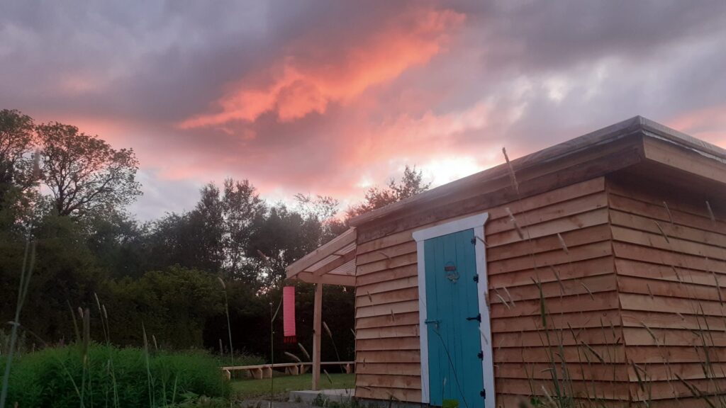 Colourful evening sky over the glamping site at Boglands