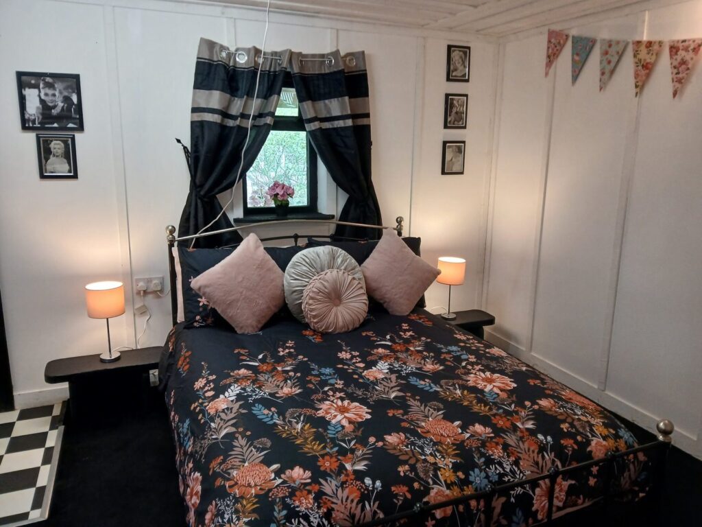 Double bedroom with floral bedspread at Hen Party Glamping